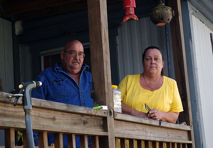 Bomar (left) and Diana Kelley pose outside their Big Pine Key, Fla., home, which suffered significant damage when Hurricane Irma struck Florida on Sept. 10, 2017. Photo by Gustavo Vasquez, UMNS.