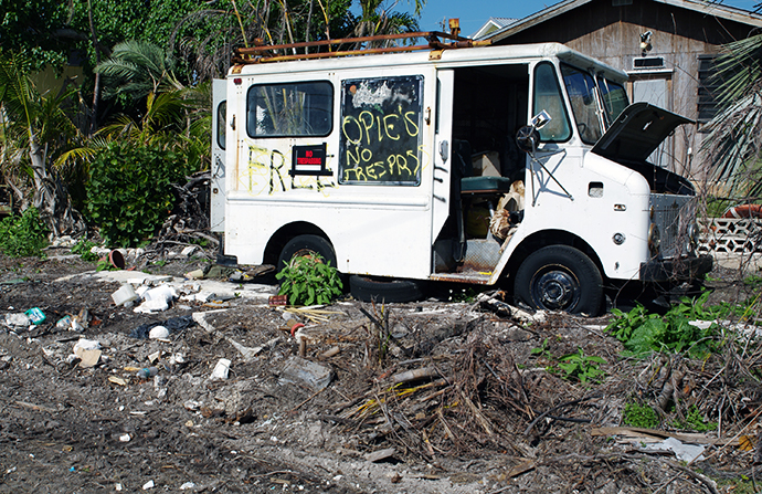 A heavily damaged service truck sits in the yard of an abandoned home in Big Pine Key, Fla. Photo by Gustavo Vasquez, UMNS.