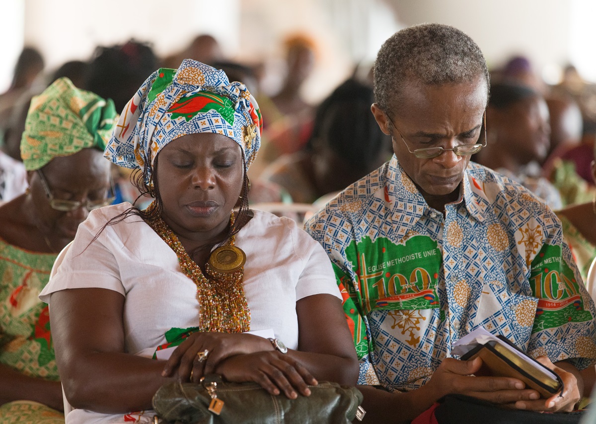 Parishioners pray during worship at Canaan United Methodist Church in Abidjan, Côte d'Ivoire. Church leaders have been working to determine which parts of The United Methodist Church’s policy book must apply throughout the multinational denomination and what parts can be adapted for use in Africa, Europe and Asia. Photo by Mike DuBose, UMNS.