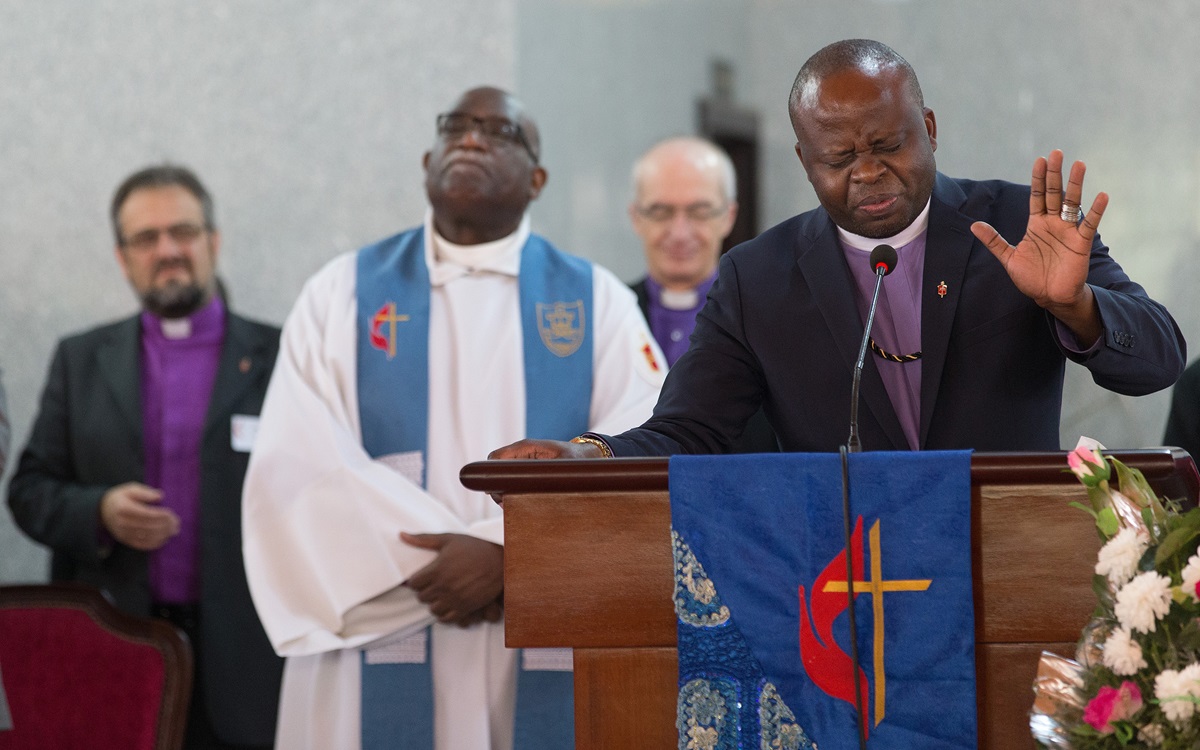Bishop Mande Muyombo (right) prays at Canaan United Methodist Church in Abidjan, Côte d'Ivoire, where members of the Standing Committee on Central Conference Matters worshipped during their meeting. One issue before the group is where to place five new bishops in Africa. Mande, who serves in Democratic Republic of Congo and is the denomination’s most recently elected bishop, is joined by (from left) Bishops Harald Rückert, Gregory Palmer and Patrick Streiff. Photo by Mike DuBose, UMNS.