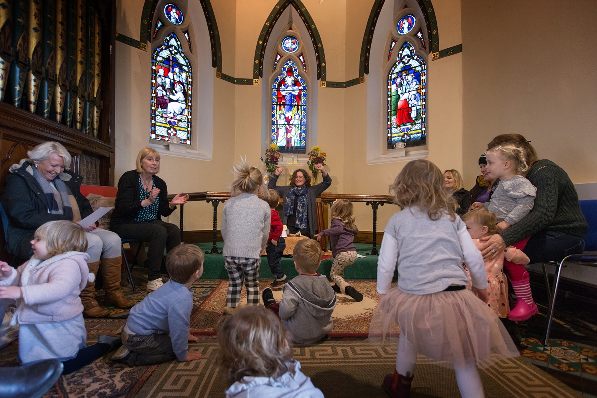 The Rev. Katy Thomas (rear) presides over a "Tiddly Nativity" activity for young children at St. Mary's Methodist Church in Handforth, England. The church is one of three Thomas serves in the Greater Manchester area. Photo by Mike DuBose, UMNS.