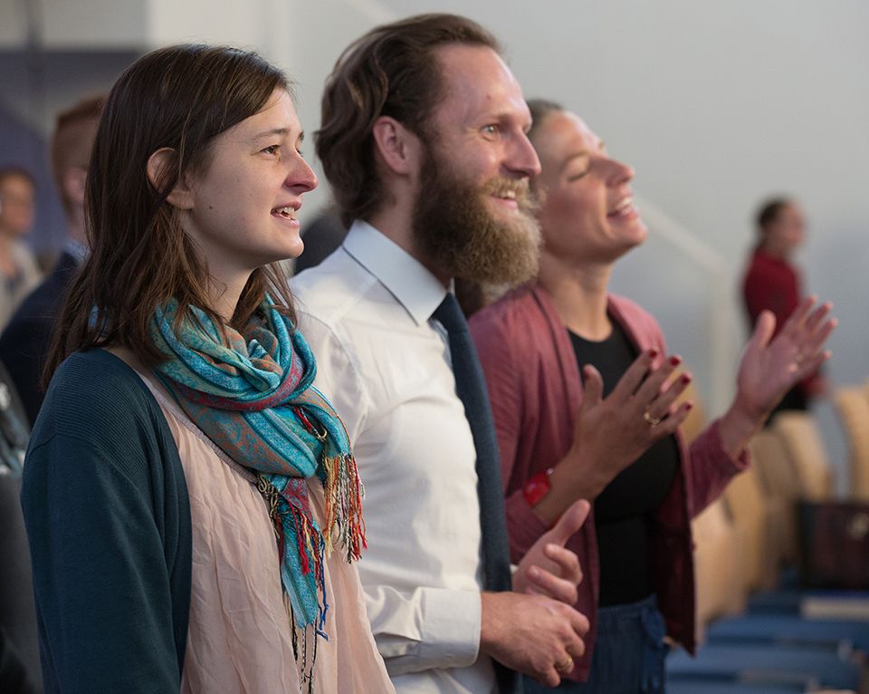Parishioners sing during worship at the United Methodist Church of the Redeemer in Munich, Germany. From left are Jula Carlsen and Daniel  and Carina Kuß. Photo by Mike DuBose, UMNS.