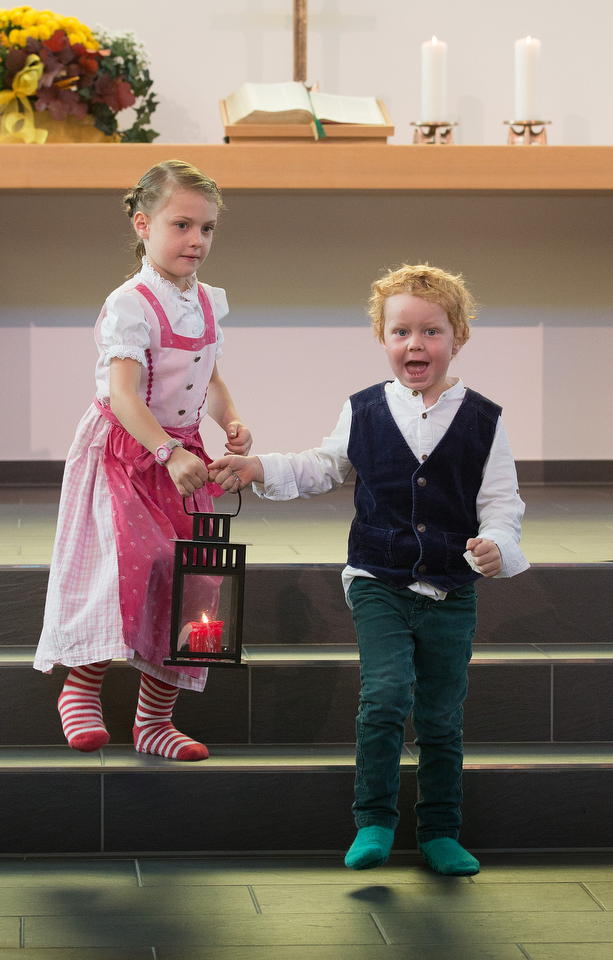 Selma (left) and Arthur Härtel carry the lantern to lead the way for children's church at the United Methodist Church of the Redeemer in Munich, Germany. Photo by Mike DuBose, UMNS.