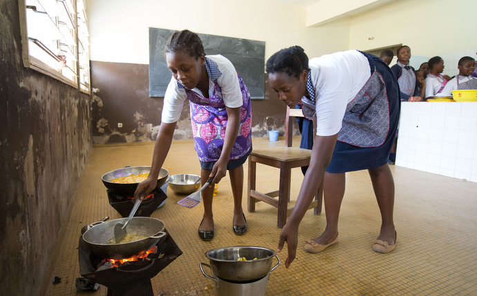 Michelle Ade Eba (left) and Grace Sossonan fry potatoes in a home economics class at the United Methodist Anyama School in Abidjan. Photo by Mike DuBose, UMNS.