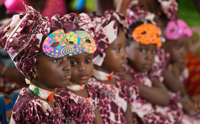 Students wearing Mardi Gras costumes listen to their teacher at the United Methodist Anyama School in Abidjan. Photo by Mike DuBose, UMNS.