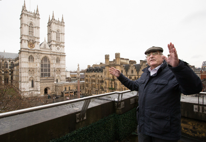 Frank Waller points out London landmarks from the balcony of Methodist Central Hall, Westminster, including Westminster Abbey (left background). Waller is assistant visitor services manager for Methodist Central Hall. Photo by Mike DuBose, UMNS.