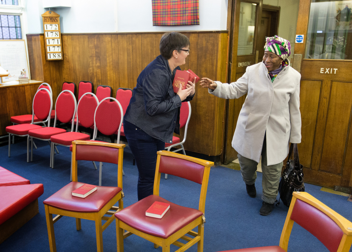The Rev. Janet Corlett (left) welcomes Frances Dakowa for a prayer and praise service at Bermondsey Central Hall Methodist Church. Photo by Mike DuBose, UMNS.