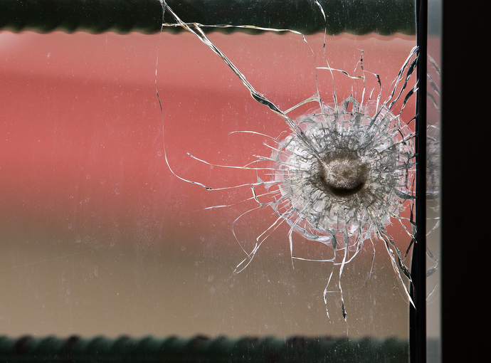A bullet hole in a newsroom window at The Voice of Hope serves as a reminder of election-related violence in 2011. The station remained on the air during the crisis and several staffers took shelter there. Photo by Mike DuBose, UMNS.