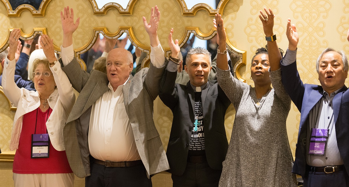 Attendees at the United Methodist Council of Bishops meeting in Chicago join in the "Praying Our Way Forward" closing worship service. The council deliberated on its final proposals to next year’s special General Conference that will address decades of division over how the church should minister with LGBTQ individuals. From left are: Jolynn Lowry, Bishop J. Michael Lowry, the Rev. Alex da Silva Souto and Bishops Cynthia Moore-Koikoi and Hee-Soo Jung. Photo by Mike DuBose, UMNS.