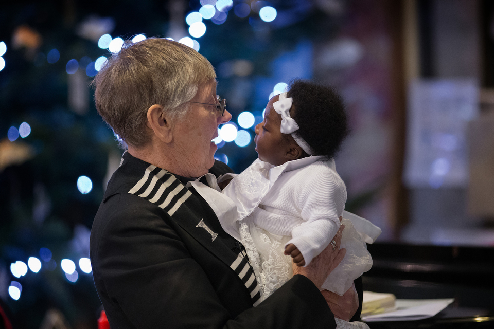 The Rev. Jennifer Potter holds Abigail Bedu Addo during her baptism at Wesley's Chapel in London. The congregation, with roots in the 18th century, draws Methodists from around the world. Photo by Mike DuBose, UMNS.