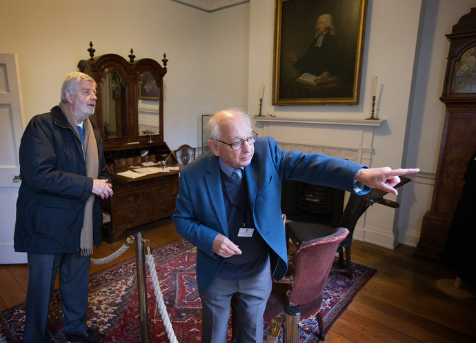 Tour guide Allen Steel (right) points out the gravesite of Susanna Wesley, mother of John and Charles Wesley, through a window in the study at Wesley's Chapel. At left is the Rev. John Lampard, a retired minister and member of the congregation at the historic church. Photo by Mike DuBose, UMNS.