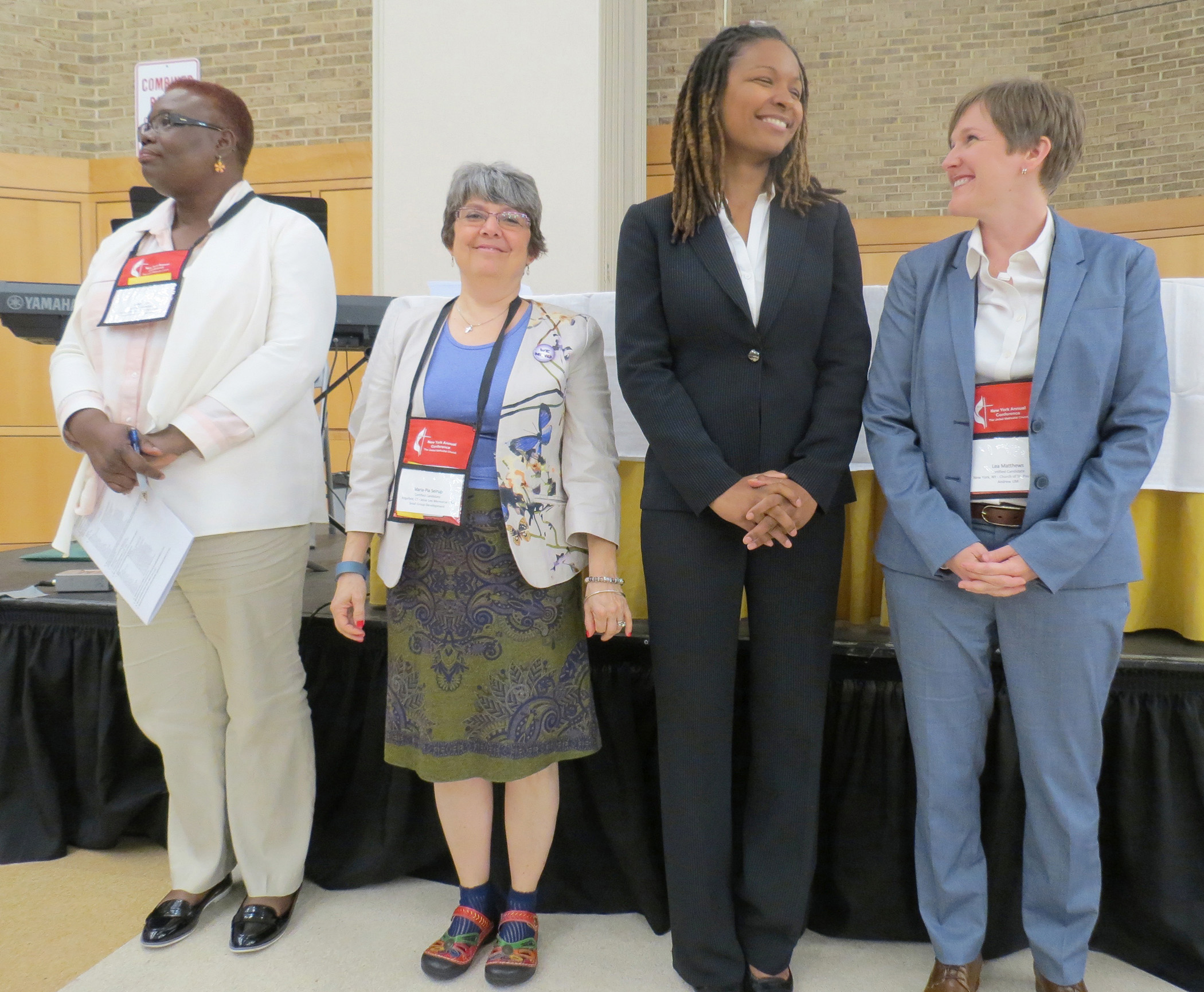 Elyse Ambrose, second from right, and Lea Matthews, far right, were among group approved as provisional deacons by the New York Conference. Photo by Joanne Utley
