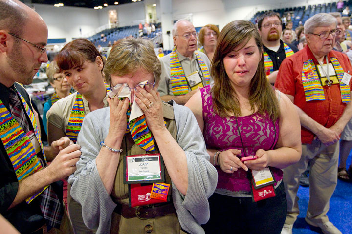 Jo Ann Carlotto, delegate from the New England Annual (regional) Conference, wipes her eyes with a rainbow stole after delegates voted to maintain The United Methodist Church's stance on sexuality. A UMNS photo by Mike DuBose.