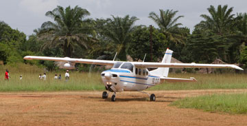 Gaston Ntambo taxis the Wings of the Morning plane off the dirt runway in Kamina. A UMNS photo by Mike DuBose.