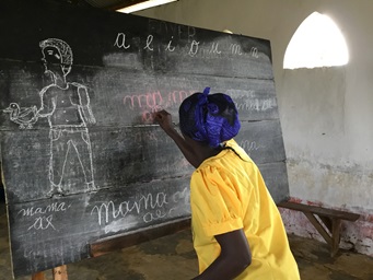 A woman writes on a chalkboard during training provided for the wives of theology students at Kindu United Methodist University in the Democratic Republic of Congo. The seminary students are often accompanied by their spouses, and classes in literacy, cooking and sewing support the women in their future role as pastors’ wives. Photo by Judith Osongo Yanga, UMNS. A woman writes on a chalkboard during training provided for the wives of theology students at Kindu United Methodist University in the Democratic Republic of Congo. The seminary students are often accompanied by their spouses, and classes in literacy, cooking and sewing support the women in their future role as pastors’ wives. Photo by Judith Osongo Yanga, UMNS.