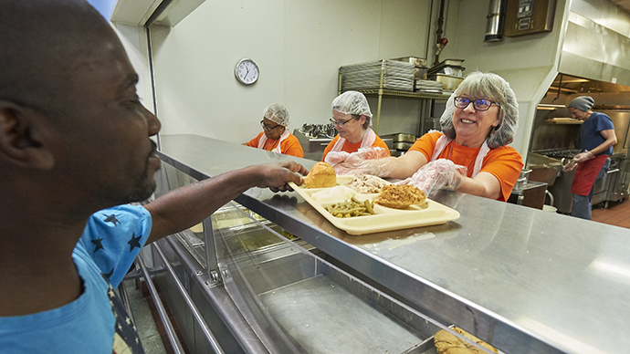 Members of United Methodist Women serve lunch to hungry people at the Community Kitchen on May 17, 2018, in Columbus, Ohio. The women were observing the Ubuntu Day of Service on the eve of the organization's Assembly 2018. Photo by Paul Jeffrey for United Methodist Women.