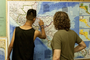 Unaccompanied minor migrants enjoy four days at a United Methodist summer camp. They point out their home towns and trace the journey they took to arrive at U.S. border on a large wall map. Photo courtesy of California-Pacific Conference.
