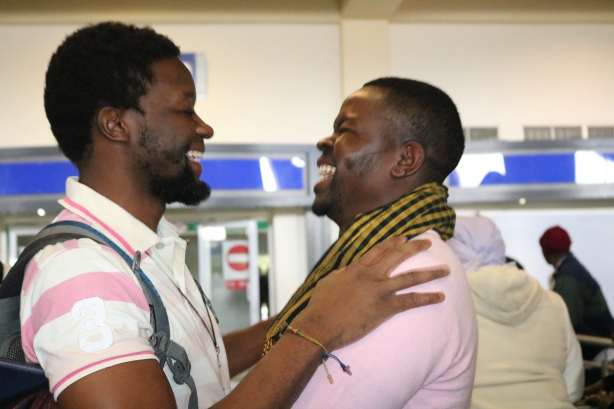 Tawanda Chandiwana is greeted by Russell Rusike, a fellow Zimbabwean Global Mission Fellow, at the airport in Harare, Zimbabwe. Chandiwana arrived home from the Philippines, where he had been detained since May 9. Photo by Taurai Emmanuel Maforo, UMNS.