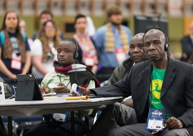 Delegate Pierre Kasongo (right) and other members of the Tanganyika delegation vote on legislation while listening to a translation of the 2016 General Conference proceedings. The Commission on General Conference said translations of the Way Forward proposals are coming. File Photo by Mike DuBose, UMNS.