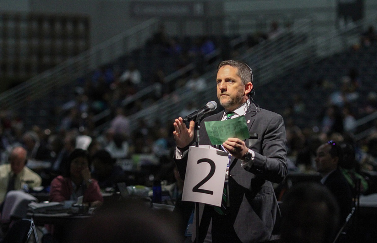 The Rev. Mark Holland of the Great Plains Conference makes a motion during the 2016 United Methodist General Conference in Portland, Ore. He was part of group of delegates who met July 13-15 in Nashville, Tenn., to build relationships and discuss the One Church Model. File photo by Maile Bradfield, UMNS.