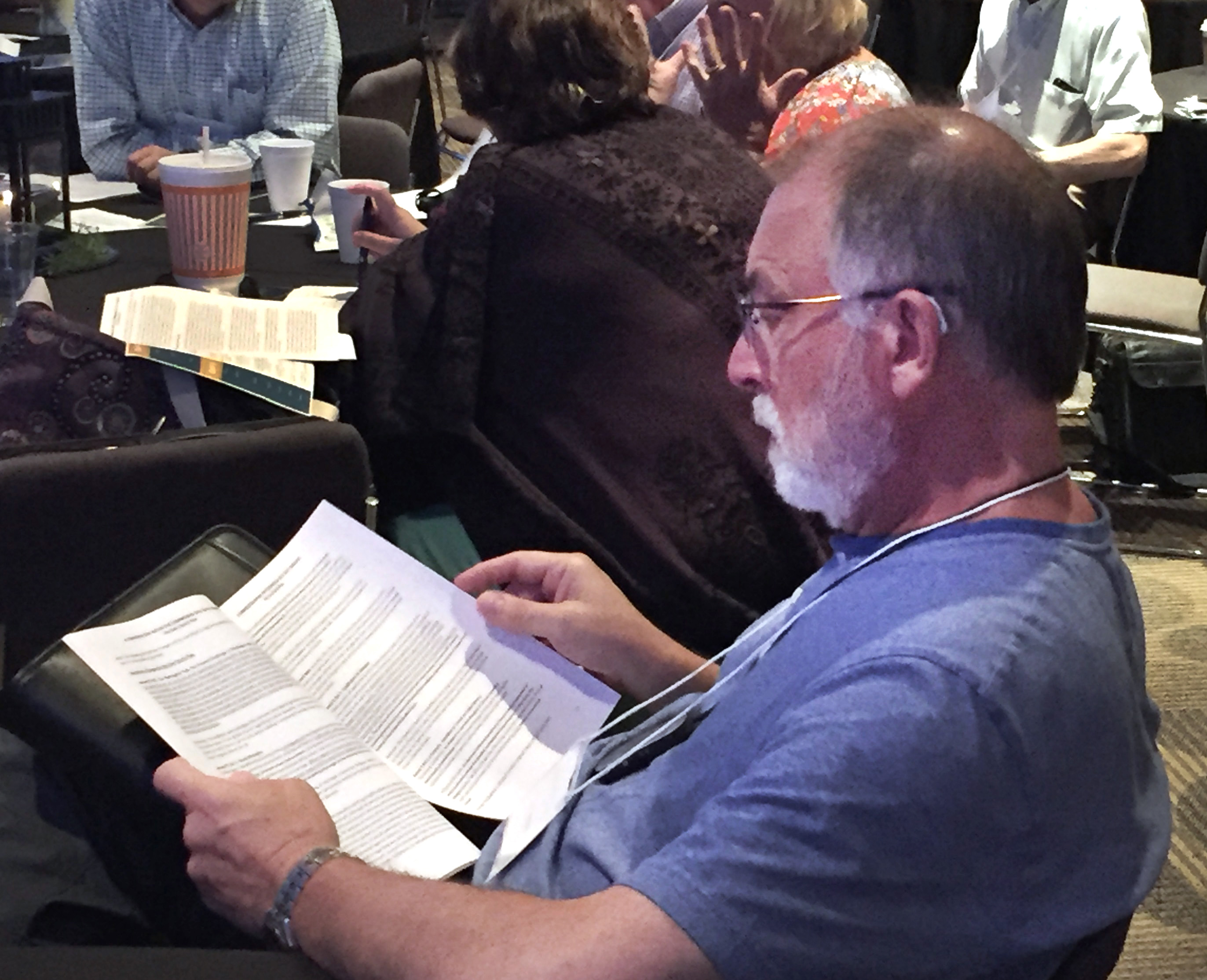 The Rev. Tom Steagald of Hawthorne Lane United Methodist Church in Charlotte, North Carolina, reads the One Church Plan during a break at the July 17 Uniting Methodist Conference in Dallas. The three plans and the full Way Forward report were part of the Judicial Council’s October docket. Photo by Sam Hodges, UMNS. 