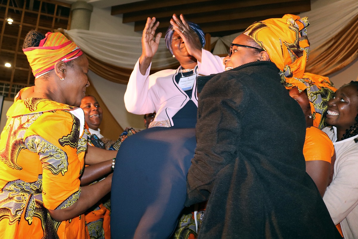 Clergywomen from Mozambique lift Bishop Joaquina F. Nhanala in her chair during a celebration of her service to The United Methodist Church at Africa University. Photo by Eveline Chikwanah, UMNS.