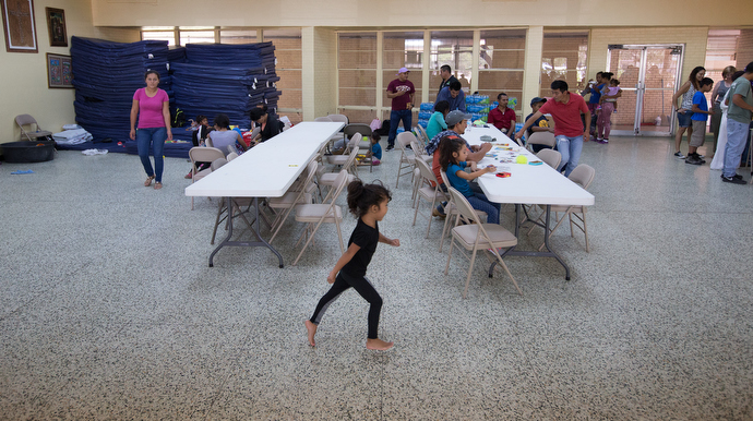 A young girl scampers across the cool terrazzo floor while families rest and relax at an overflow shelter for recent immigrants at the Basilica of Our Lady of San Juan del Valle. Photo by Mike DuBose, UMNS.