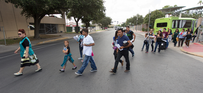Blanca Muñoz (left) leads immigrants from the bus station to the Catholic Charities Humanitarian Respite Center in McAllen, Texas. Photo by Mike DuBose, UMNS.