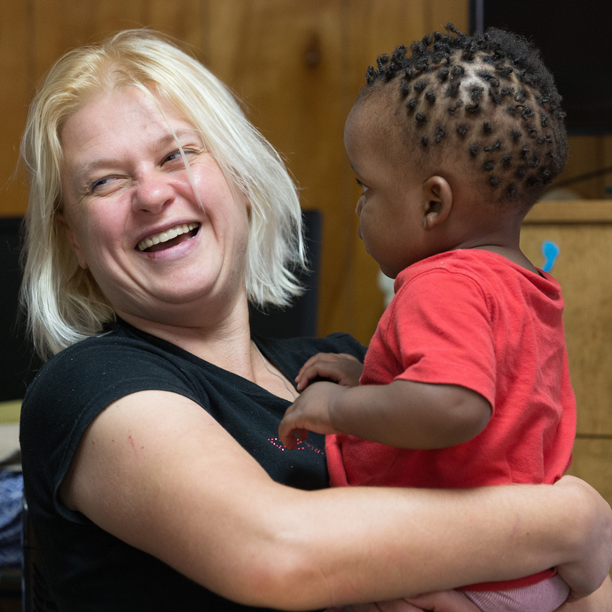 Julia, an immigrant from Ukraine, plays with Andonis, a baby from Congo at La Posada Providencia, an emergency shelter for immigrants and asylum seekers in San Benito, Texas Photo by Mike DuBose, UMNS.