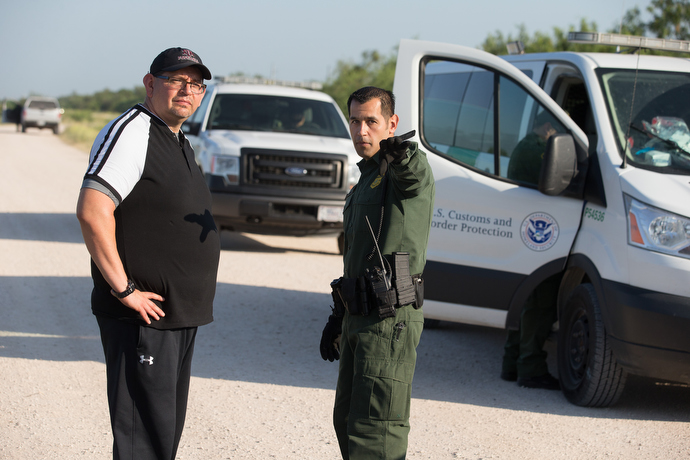The Rev. Robert Lopez (left) learns firsthand about the work of the U.S. Border Patrol from agent Robert Rodriguez along the Rio Grande near McAllen. Lopez is superintendent of The United Methodist Church's El Valle and Coastal Bend Districts in the Rio Texas Conference. Photo by Mike DuBose, UMNS.