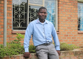 Joseph Kaipa, farm supervisor, outside his office. Photo by Francis Nkhoma, UMNS. 
