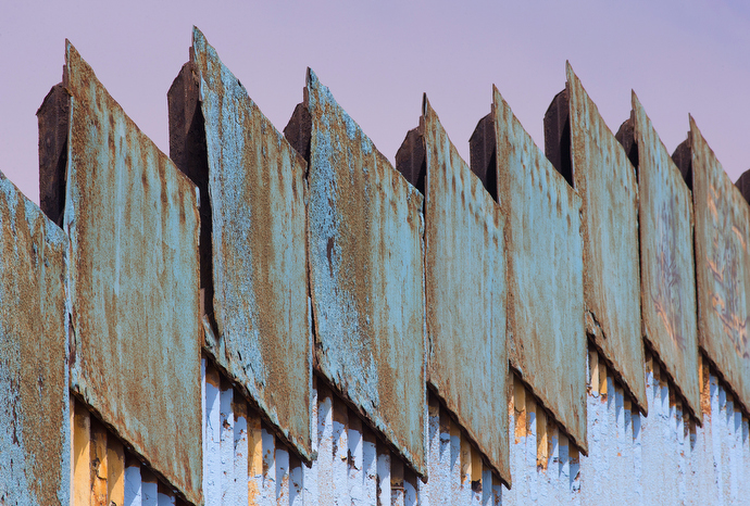 Steel plates stand atop the posts of the border fence that marks the boundary between Mexico and the U.S. at El Faro Park in Tijuana. Photo by Mike DuBose, UMNS.
