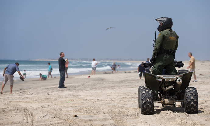 A U.S. Border Patrol agent keeps watch over beach goers along the border between the U.S. and Mexico just outside Friendship Park near San Diego. Photo by Mike DuBose, UMNS.