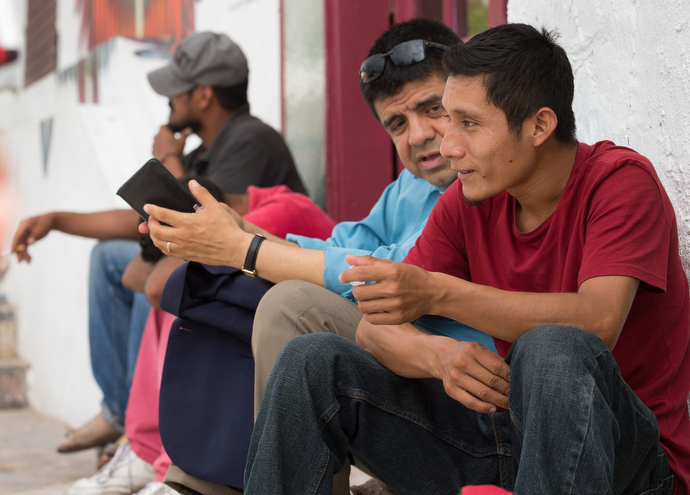 The Rev. Joel Hortiales (center) visits with Elias from the Mexican state of Chiapas outside the Border Angels shelter for migrants in Tijuana. Photo by Mike DuBose, UMNS.