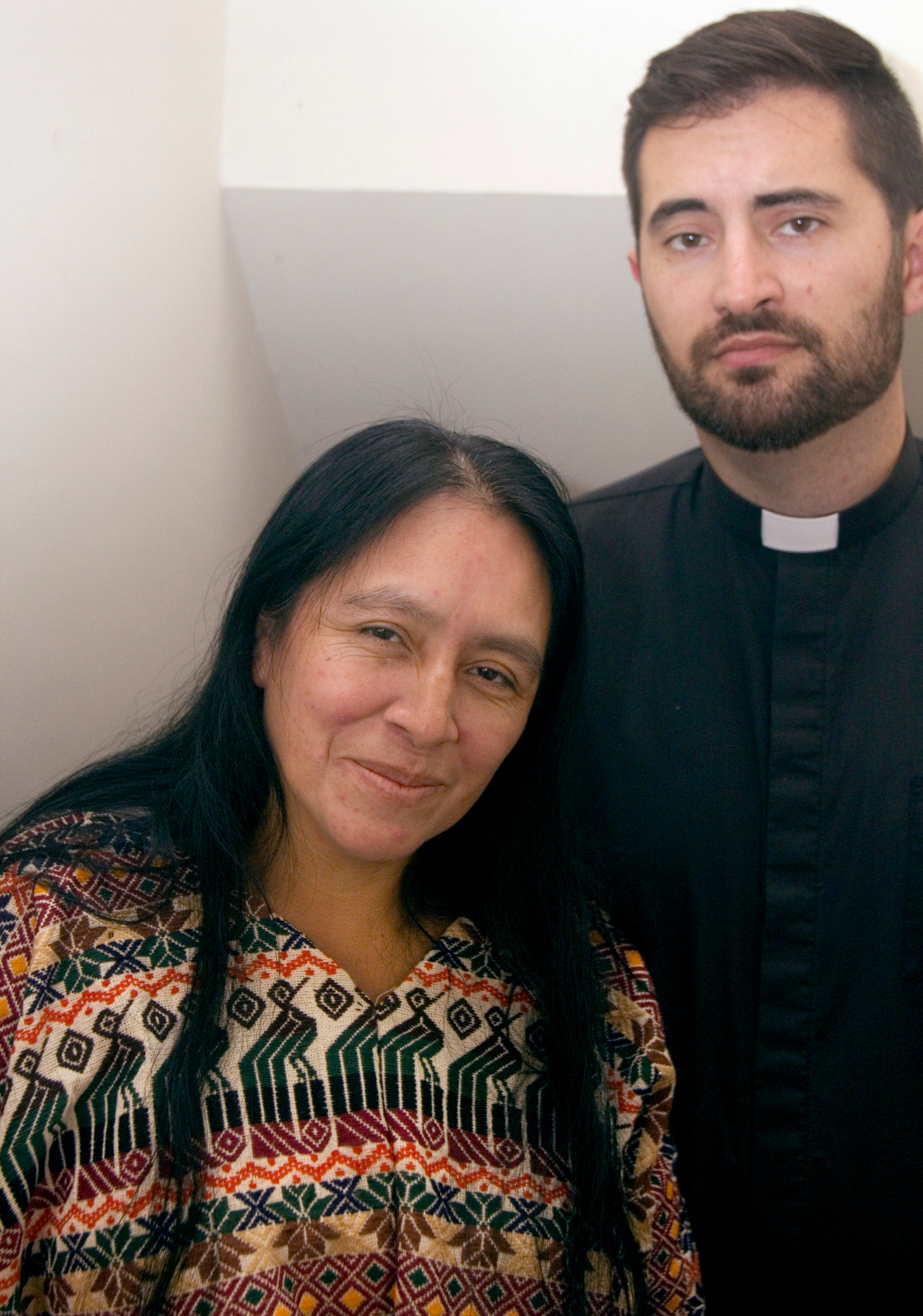 Maria Chavalan Sut stands with the Rev. Isaac Collins, pastor of Wesley Memorial United Methodist Church, at a press conference held Oct. 8. Chavalan Sut is living in the church to avoid deportation. Photo: © Richard Lord.