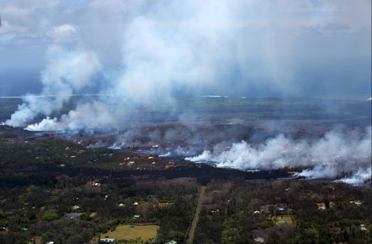 This aerial view shows plumes of smoke and volcanic gas caused by lava moving into residential areas in the Leilani Districts, Hilo, Hawaii. Photo by Pfc. Trevor Rowell, U.S. Marine Corps. 