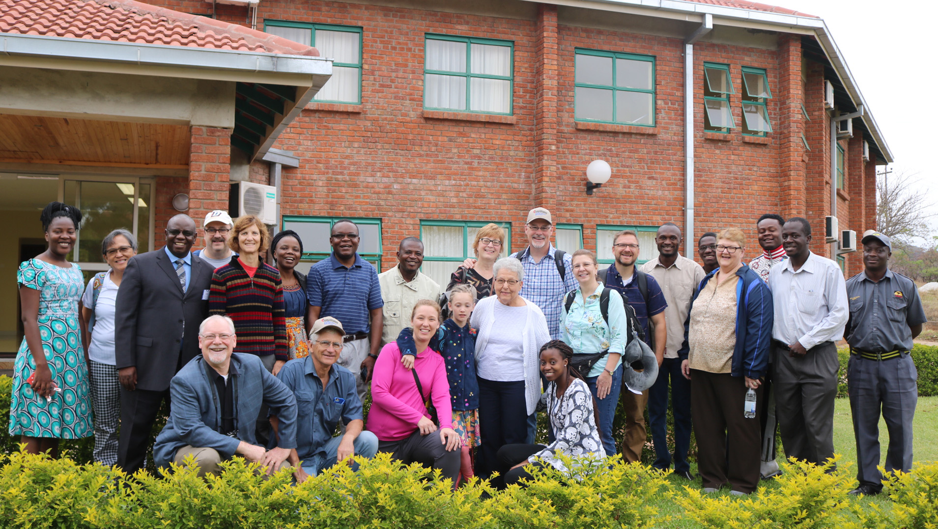 Members of a United Methodist delegation from Iowa and staff from Africa University pose in front of the Ubuntu Center, a retreat and meeting facility at the United Methodist-related institution in Mutare, Zimbabwe. Photo by Eveline Chikwanah.