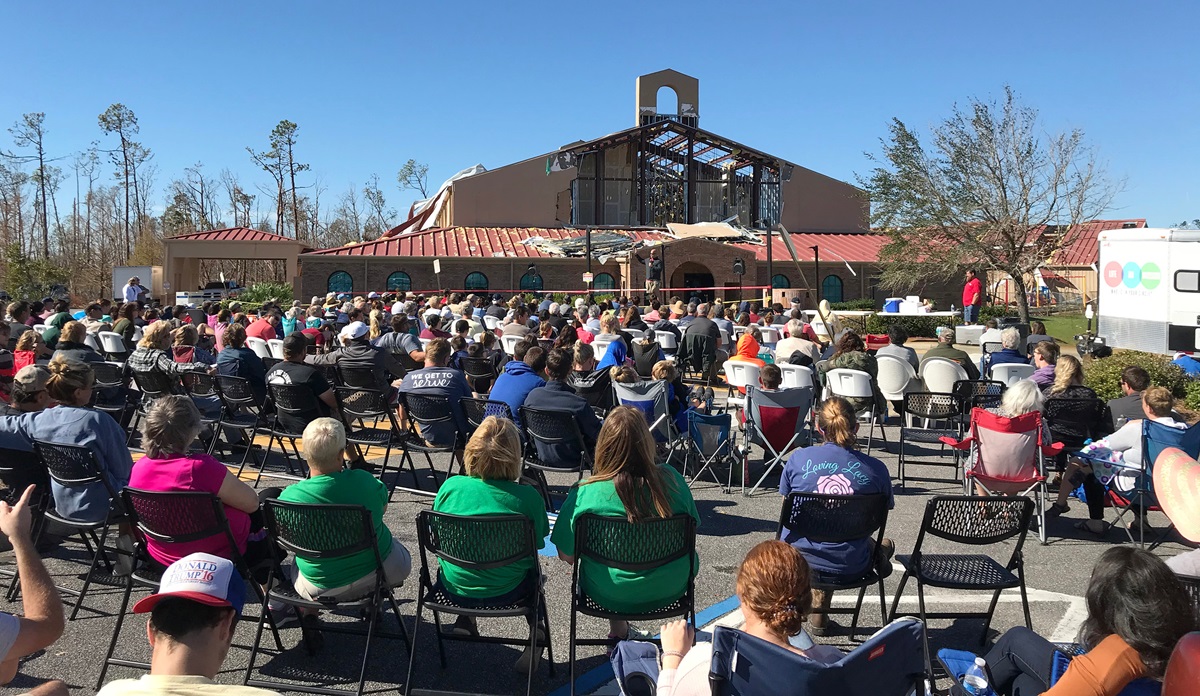 The congregation of Lynn Haven United Methodist Church in Panama City, Fla., worships in the parking lot of their sanctuary, which was destroyed by Hurricane Michael. About 250 worshipers attended. Photo courtesy of Lynn Haven United Methodist Church.