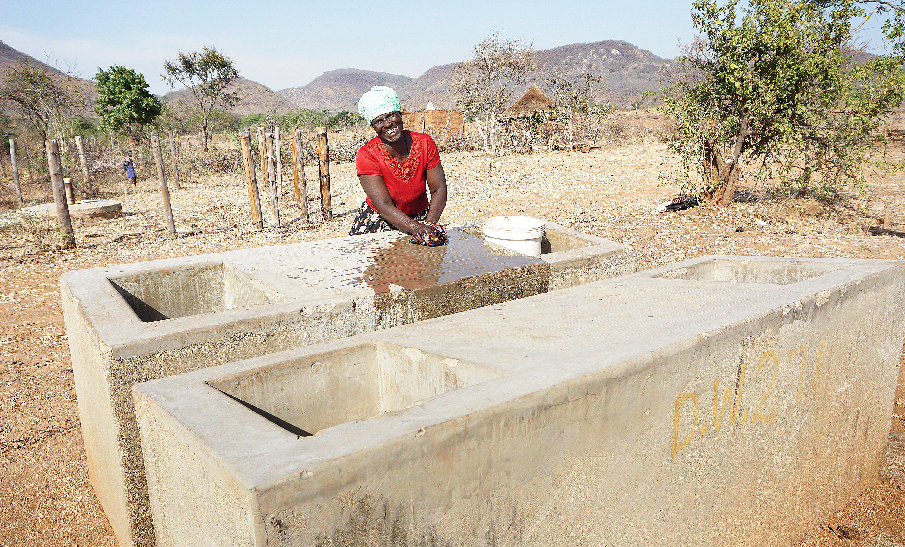 Maria Mandipaza tries out the new laundry basin donated by United Methodists from Norway. Photo by Kudzai Chingwe, UMNS.