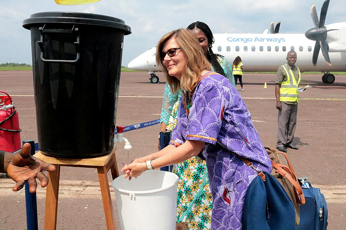 The Rev. Neelley Hicks washes her hands at Kindu National Airport in Congo. The washing station and temperature monitors were installed at the airport and other entrances to the city to help prevent the spread of Ebola. Hicks is executive director of Harper Hill Global, which is helping raise awareness about Ebola. Photo by Chadrack Tambwe Londe, UMNS.
