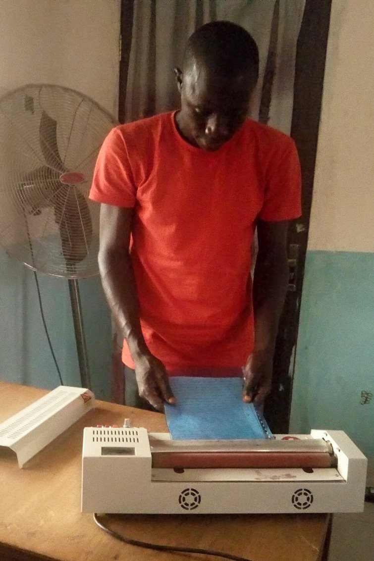 A student makes photocopies at the Northern Nigeria Conference’s computer training center in Gombe, Nigeria. The center has a new solar energy system that is helping the conference and its students save money. Photo by Daniel Garba.