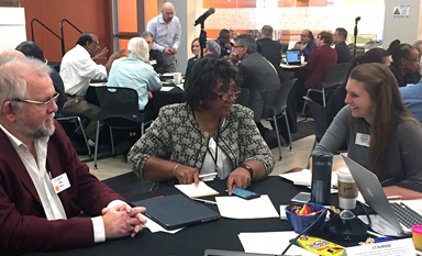 Connectional Table members talk about ways to strengthen relationships across all levels of the denomination. Pictured from left are the Rev. Ole Birch of Denmark, Benedita Penicela-Nhambiu of Mozambique and Michelle Hettman of the Virginia Conference. Photo by Heather Hahn, UMNS.
