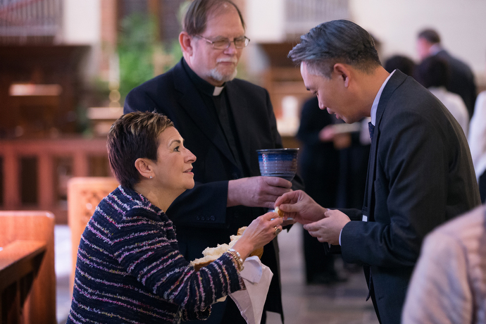 United Methodist Bishop Cynthia Fierro Harvey (left) and the Rev. Chris Ferguson of the World Communion of Reformed Churches serve Holy Communion during closing worship at the roundtable. Photo by Mike DuBose, UMNS.