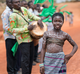 A young  girl in traditional clothing welcomes visitors to a recently opened United Methodist church in Gouabo, Côte d'Ivoire. Photo by Mike DuBose, UMNS.
