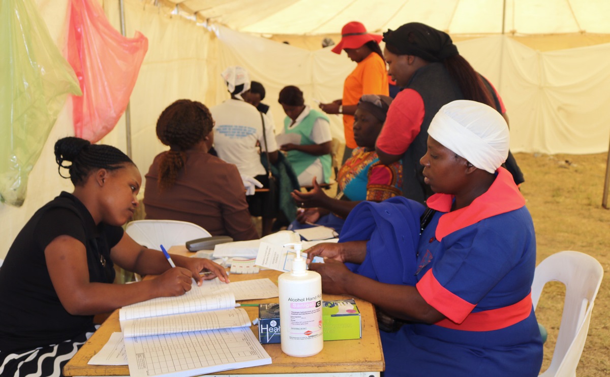 Women check in at registration desks before entering private bays for testing. Over 400 women were screened for cervical cancer during the annual women’s convention at Clare Camping Ground in Rusape, Zimbabwe. Photo by Eveline Chikwanah, UMNS.
