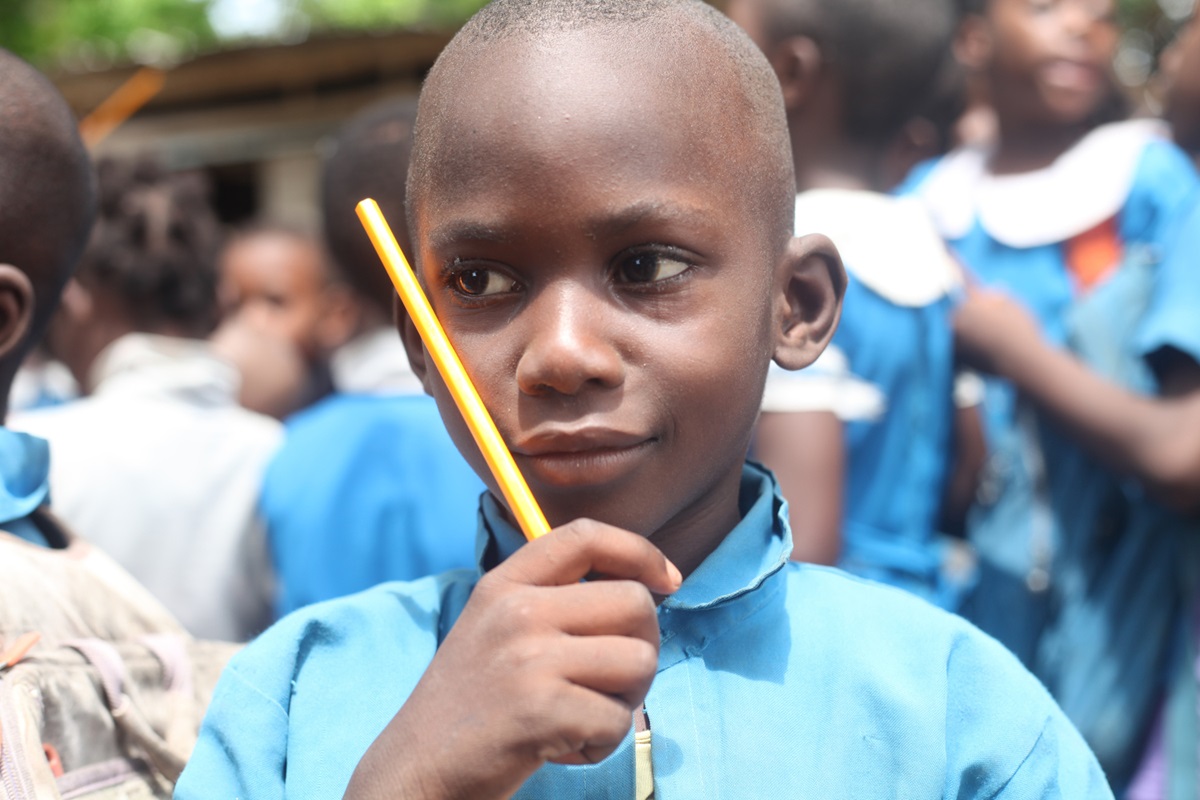 John Owona, a class four pupil in the Government English Primary School in a rural area of Cameroon, is happy with his new pencil, saying, “I will no longer wait for my friend to finish writing in class before giving me his pencil.”  Photo by Marius Bonfeu.