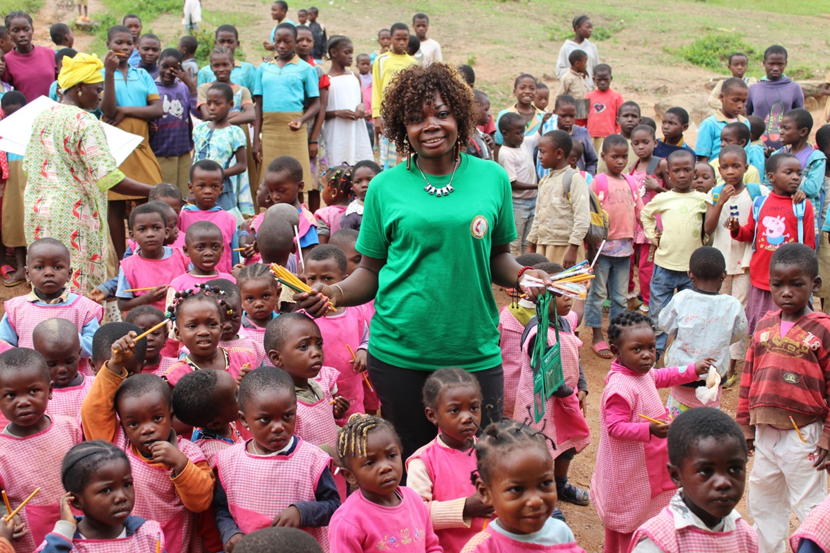 Sara Ambadiang, national president of the United Methodist Women Association Cameroon, poses with students of a government school in Lebamzip, Cameroon. Photo by Marius Bonfeu. 