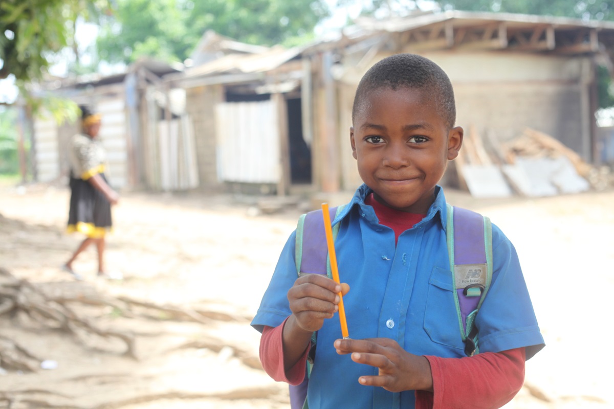 A young boy poses for a portrait after receiving his pencil from United Methodist Women in Cameroon. Photo by Marius Bonfeu.