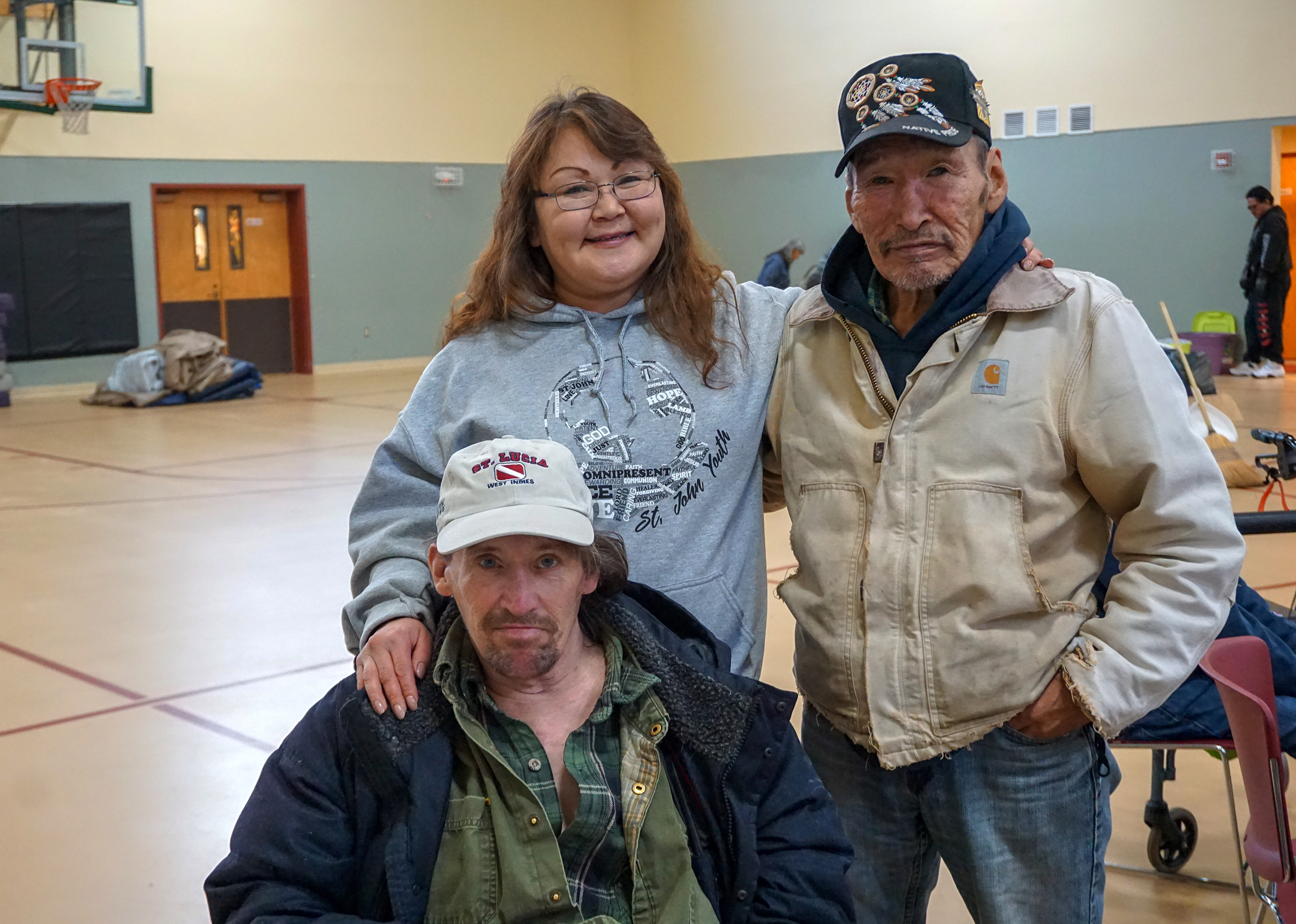 Betty Sanchez Sopcak (l), her husband Daniel (bottom), and her uncle James Sugar (r) take shelter with other residents of Karluk Manor at St. John United Methodist Church after the Nov. 30 earthquake. Photo by Anne Hillman, courtesy of Alaska Public Media.