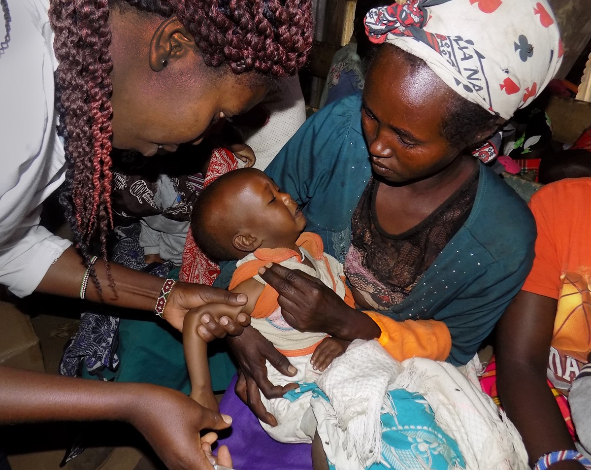 Angela Miloti holds her baby as he receives a polio vaccine at a mobile medical clinic in Gilgil, Kenya. The new clinic is a collaboration between Trinity Mission Dispensary, a Trinity United Methodist Church project, and the Rotary Club of Gilgil. Photo by Faith Wanjiru. 